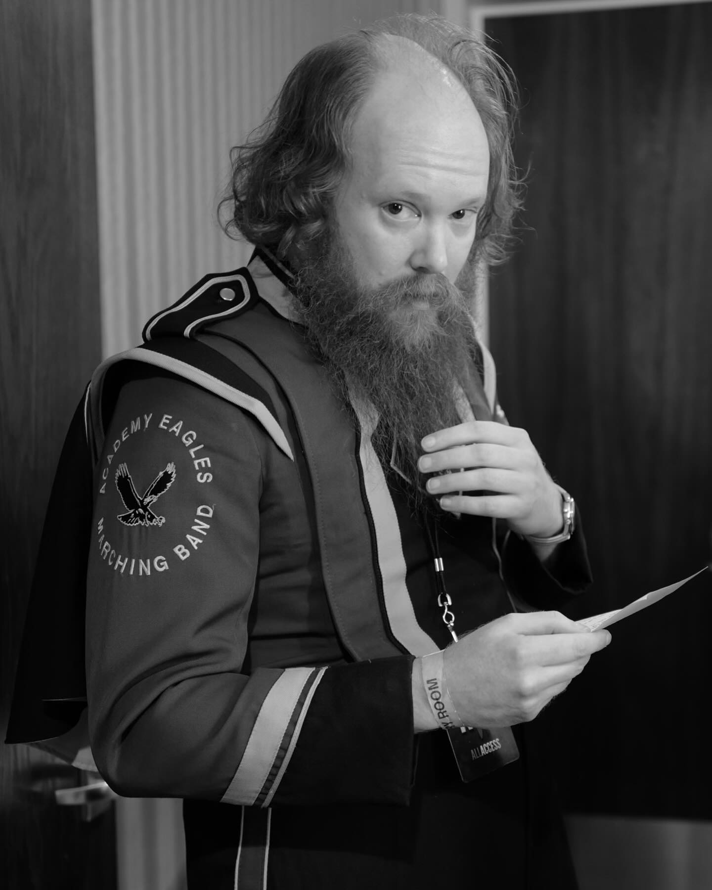 William Montgomery wearing a marching-band jacket and holding notes
